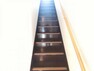 【リフォーム済】階段の写真です。床塗装・手すり交換・ノンスリップ設置・クロス張替え・照明交換を行いました。安全面を考慮し滑り止めを設置したので、登り降りも安心ですね。