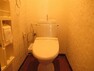 トイレ 白を基調としたオシャレなクロスのトイレです。ペーパーホルダー周りには棚もあります。（2022年1月21日　撮影）
