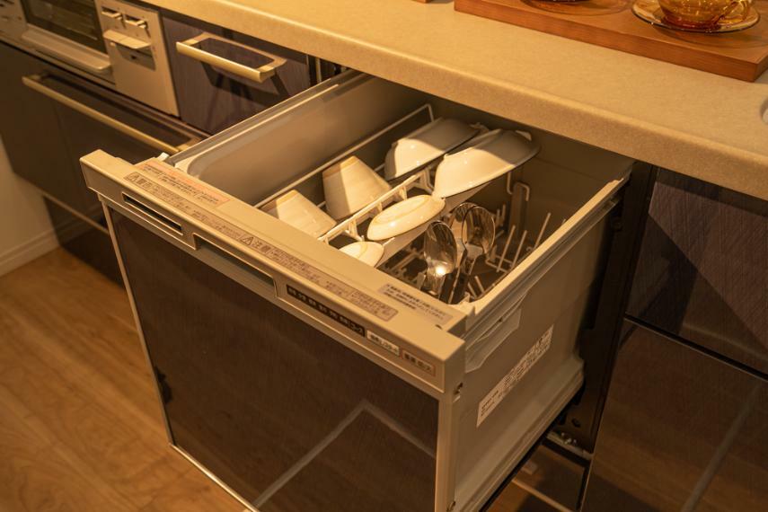 キッチンカウンター下にビルトインされた食器洗乾燥機は、スライドタイプで洗い物の出し入れも簡単。節水効果や手荒れの軽減も期待できます。食器洗いの時間を省くことで、食後の時間をご家族がふれあう時間や趣味の時間に充てることができます。（施工例同仕様）