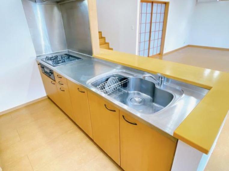 キッチン 【リフォーム済】キッチンはクリーニングを行いガスコンロは新品に交換しました。LDKを見渡せる対面キッチンです。背面には備え付けの大容量収納可能な棚が設置されております。