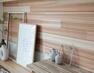 居間・リビング Style01/スギノカ  国産杉材の中でもリラックス効果のある香り成分の多い部材を使用した、杉板パネルをリビングの一角に採用。森林浴のような心地良さを創出します。
