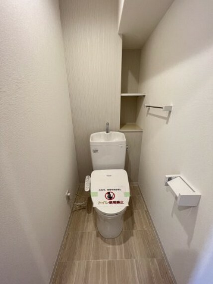 トイレ 快適な温水洗浄便座付きのトイレ。棚には、トイレットペーパーや掃除用品などが収納できます。
