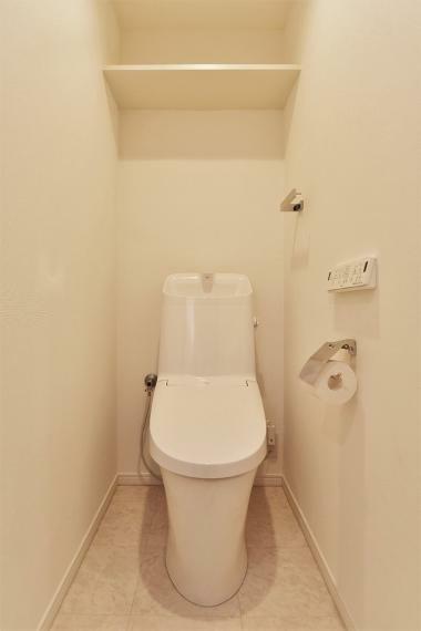 トイレ 快適にお使いいただける温水洗浄便座付トイレです。上部に収納棚も設置されております。